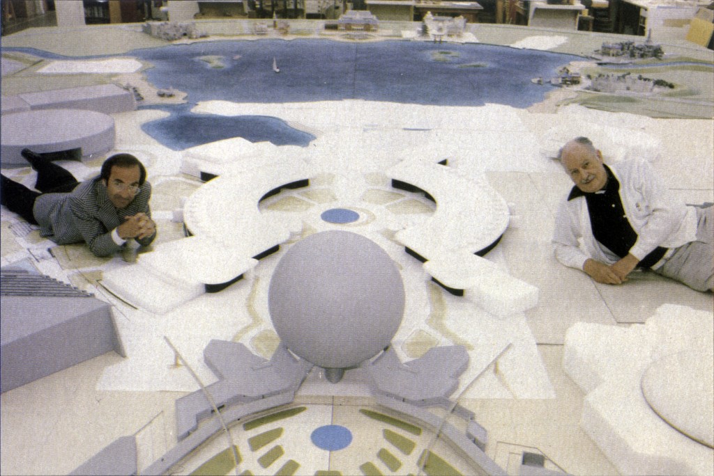 Marty (L) and John Hench (R) lounging on the scale model of Epcot Center