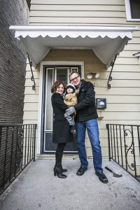 Dina Benadon and Brent Young stand on the front porch of the Walt Disney birthplace home, with their young son Truman. Photo © Stephen Green Photography