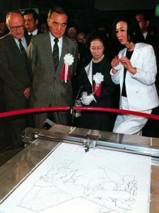 In the US Pavilion at Tsukuba Expo 85, Japan Prime Minister Nakasone and company watch "Aaron" the robot draw. Photo courtesy James Ogul