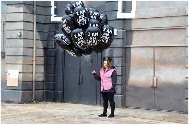 A Dismal balloon seller, note the ears… Did you ever imagine that people would pay to carry a balloon proclaiming “I am an imbecile”? Maybe Banksy doesn’t like us after all.