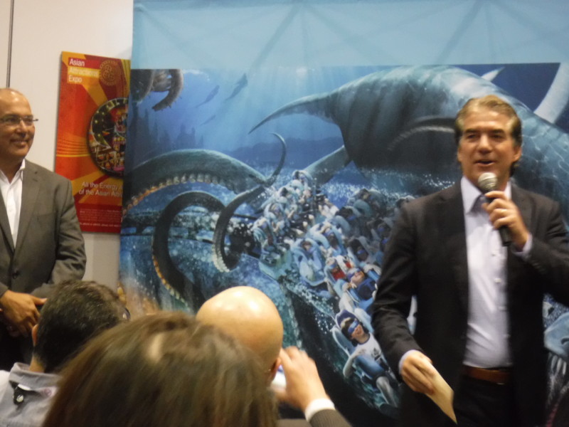 SeaWorld Chief Creative Officer Anthony Esparza watches as Joel Manby describes Kraken VR