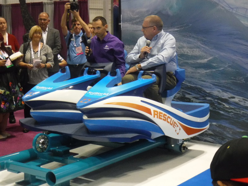 Mike Denninger and Carl Lum, President of SeaWorld San Antonio try out Wave Breaker's car.