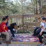 kids playing checkers outside – Photo Courtesy of Talking Rocks Cavern
