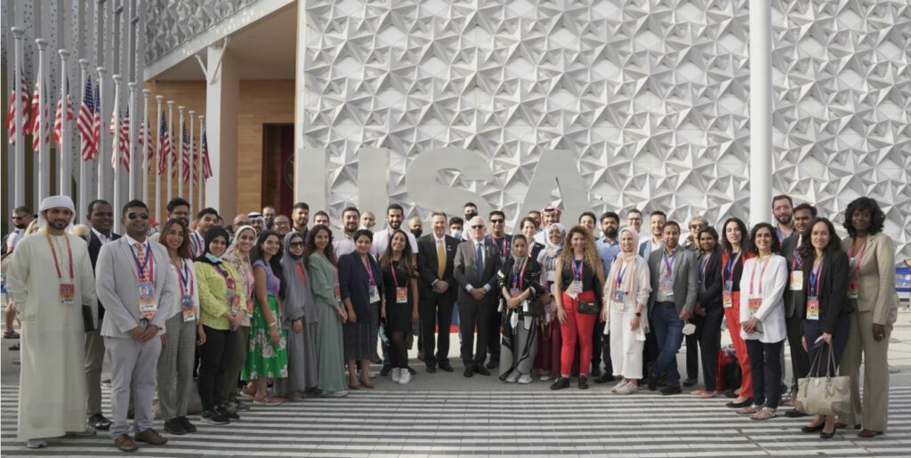 Commissioner General Robert Clark with the Young Leaders Fellows, at the USA Pavilion, Expo 2020 Dubai