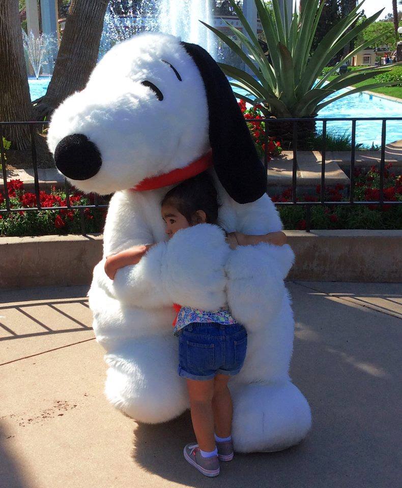 Snoopy hugs a young fan at California's Great America theme park