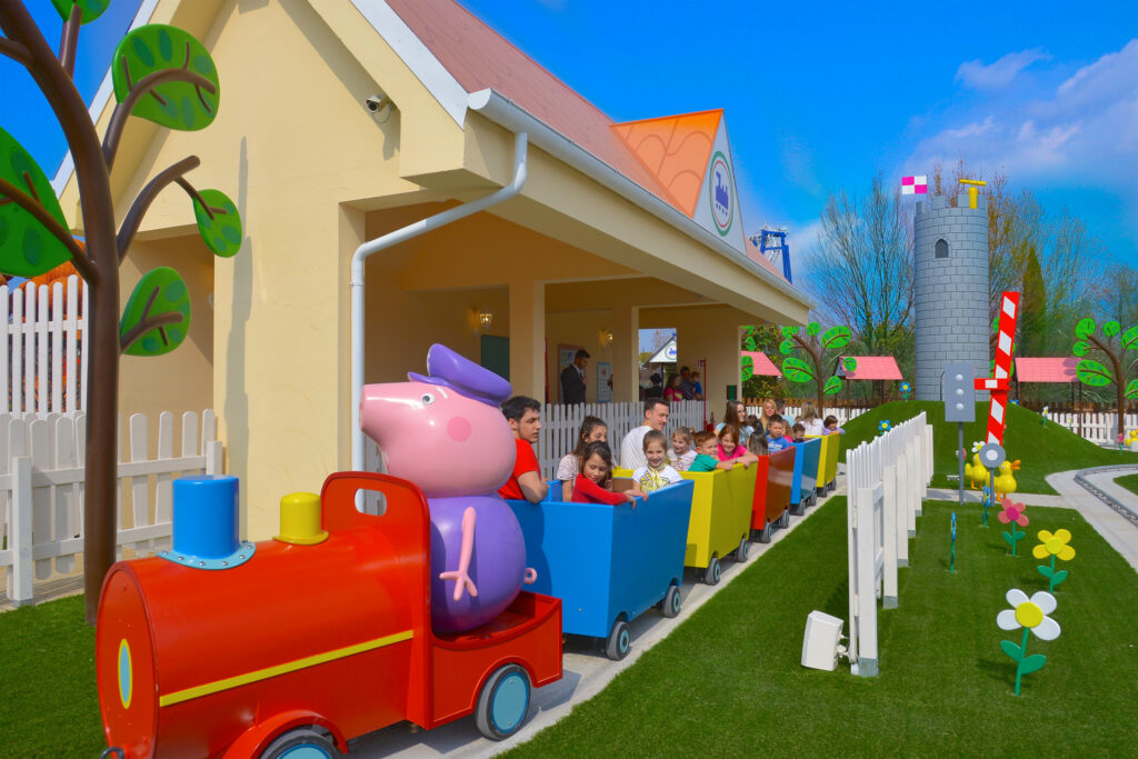 Peppa Pig drives a train around her land at Gardaland in Italy